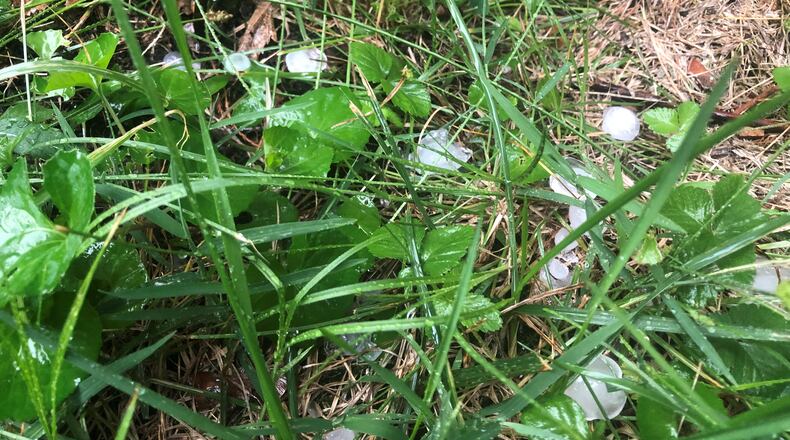 Hail the size of gumballs collects in the grass in South Park Friday evening, Jan. 18, 2021, in Dayton. CORNELIUS FROLIK/STAFF