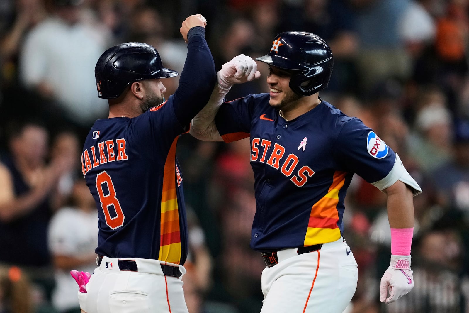 Houston Astros' Yainer Diaz, right, celebrates with Christian Walker (8) after hitting a home run during the third inning of a baseball game against the Cincinnati Reds in Houston, Sunday, May 11, 2025. Isaac Paredes and Christian Walker also scored. (AP Photo/Ashley Landis)