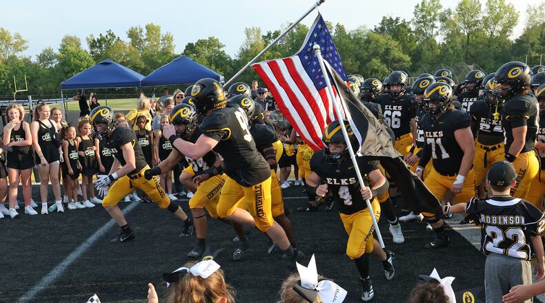 The Centerville Elks take the field before their game against St. Xavier Frday, August 30, 2024. BILL LACKEY/STAFF