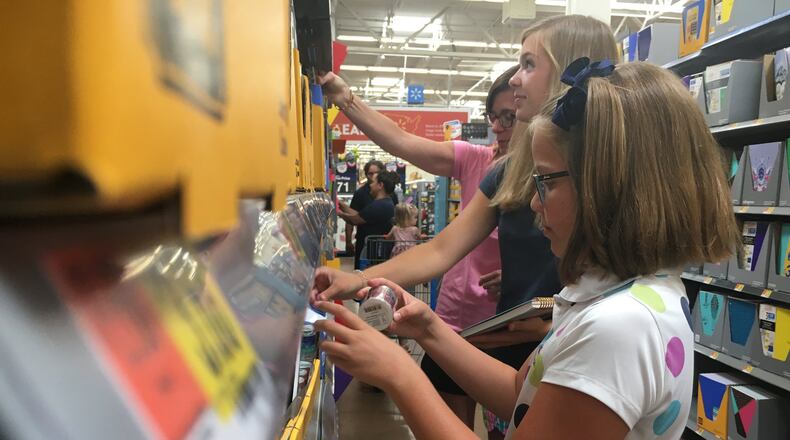 Susan Bradley and two of her three daughters, Hope and Lily, of Centerville were shopping early for back-to-school supplies Tuesday. They like to beat the rush on things like folders and use tax-free weekend for clothing. STAFF PHOTO / HOLLY SHIVELY
