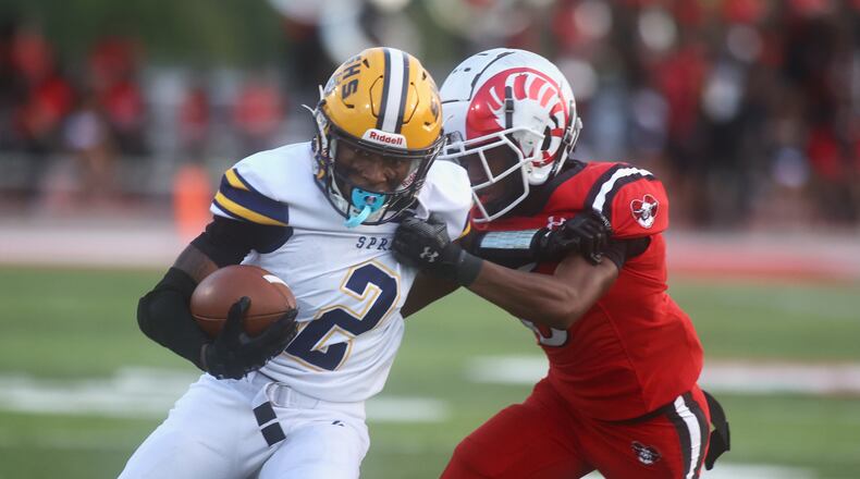 Springfield's Sherrod Lay Jr. runs the ball against Trotwood-Madison's Mike Keith on Friday, Sept. 5, 2025, at Trotwood. David Jablonski/Staff