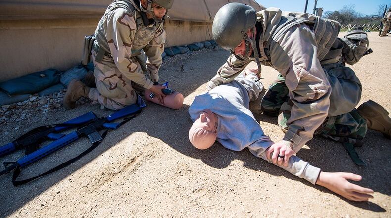 Air Force military training trainees practice exercise scenarios and tactical combat casualty care during Basic Expeditionary Airman Skills and Training at Joint Base San Antonio-Medina Annex, Texas, Feb 25. TCCC is an all-service members course that teaches service members lifesaving skills to render basic medical aid to a trauma casualty. (U.S. Air Force photo/Sarayuth Pinthong)