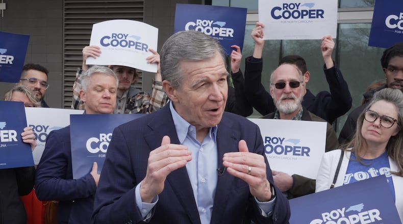 Democratic former Gov. Roy Cooper, who is running for U.S. Senate, speaks to reporters after casting his ballot on the first day of in-person early voting in the state's primary election, Thursday, Feb. 12, 2026, in Raleigh, N.C. (AP Photo/Allen G. Breed)