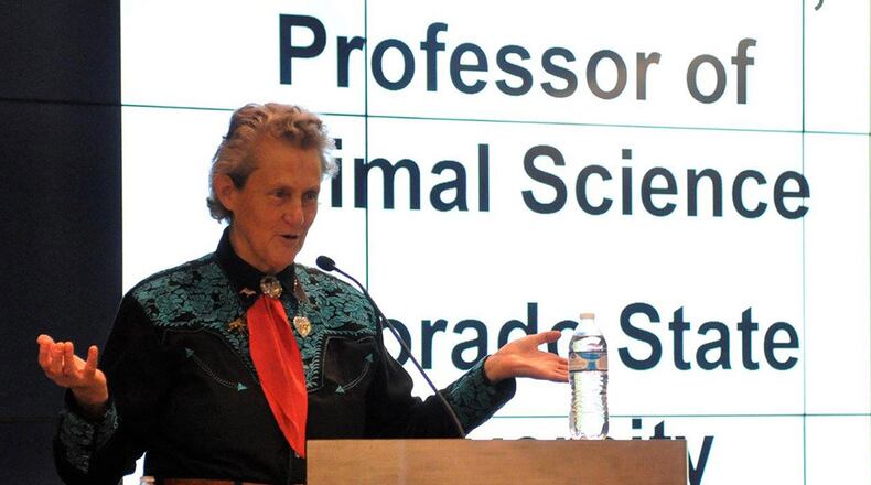 Dr. Temple Grandin greets the audience at her lecture for the Diversity Speakers Series June 28 at the Air Force Institute of Technology, sponsored by the Air Force Research Laboratory. Grandin is an acclaimed livestock industry consultant, professor of animal science at Colorado State University and autism spokesperson. (U.S. Air Force photo/Caroline Clauson)