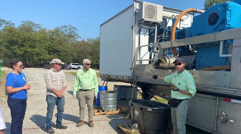 U.S. Army Engineer Research and Development Center’s Martin Page, operational water research team lead, listens as colleagues describe the algal bloom removal unit they developed with industry partner Woolpert at an event at William H. Harsha Lake in Batavia, Ohio in September 2022. Page led the team that developed the system, the research project underpining the freshwater harmful algae removal technology showcased in Ohio. Photo by Holly Kuzmitski