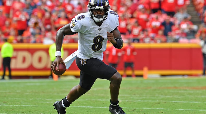 KANSAS CITY, MO - SEPTEMBER 22: Quarterback Lamar Jackson #8 of the Baltimore Ravens scrambles to the outside against the Kansas City Chiefs during the second half at Arrowhead Stadium on September 22, 2019 in Kansas City, Missouri. (Photo by Peter Aiken/Getty Images)