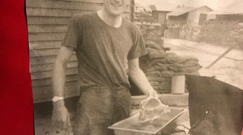 Jim Brown in Tay Nihn (Vietnam) camp on Cambodian border cooking a T-bone steak on Thanksgiving Day 1969. Sandbags on quarters in back, trying to protect camp from nightly onslaught of rockers and motars that came from Cambodia less than three miles away. CONTRIBUTED