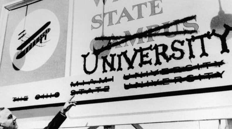 Wright State’s first president, Brage Golding, points at a former Wright State Campus sign. The school became an independent institution in 1967 and is celebrating its 50th anniversary this fall.