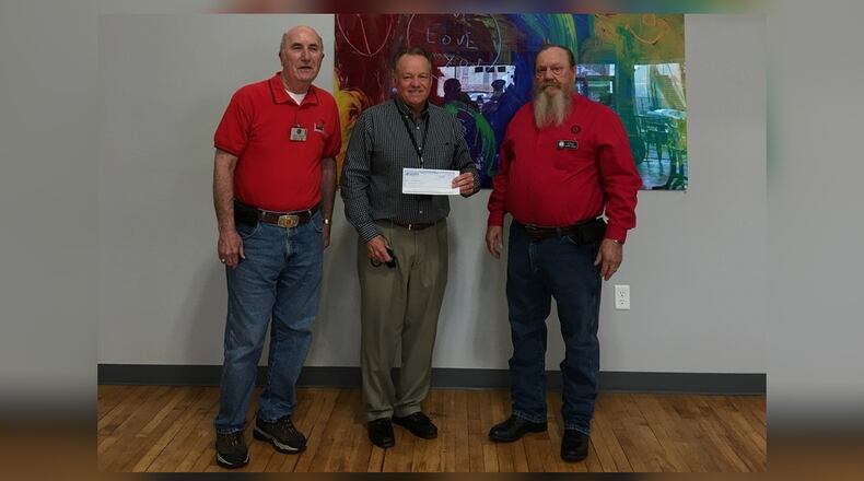 Two Xenia Lions club members present a check. CONTRIBUTED