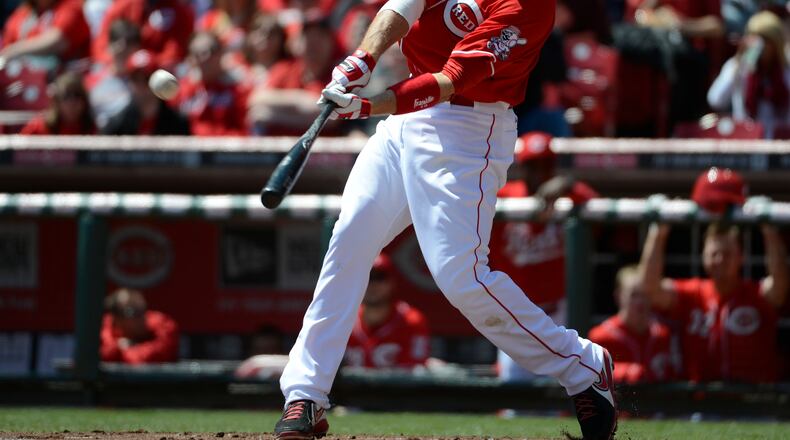 Cincinnati Reds' Joey Votto hits a solo home run in the first inning off Miami Marlins starter Alex Sanabia at Great American Ball Park in Cincinnati, Sunday, April 21, 2013. (AP Photo/Michael E. Keating)