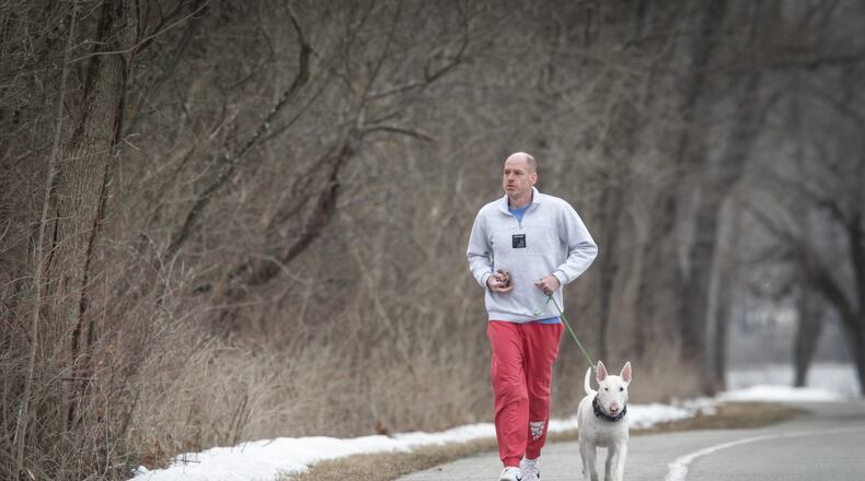 Josh Bookwalter and his dog, Cosmo get some exercise at Englewood Metro Park on Feb. 26, 2021.