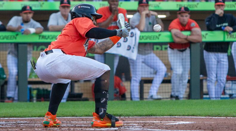 Dayton's Victor Acosta lays down a sacrifice bunt to move two runners into scoring position who later scored on Carlos Jorge's single Friday night at Day Air Ballpark. Jeff Gilbert/CONTRIBUTED