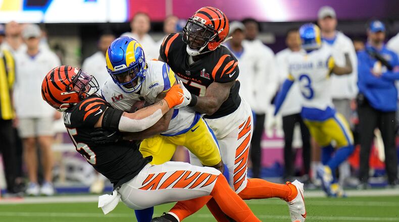 Los Angeles Rams running back Cam Akers, middle, is tackled by Cincinnati Bengals inside linebacker Logan Wilson, left, and outside linebacker Germaine Pratt during the first half of the NFL Super Bowl 56 football game Sunday, Feb. 13, 2022, in Inglewood, Calif. (AP Photo/Chris O'Meara)