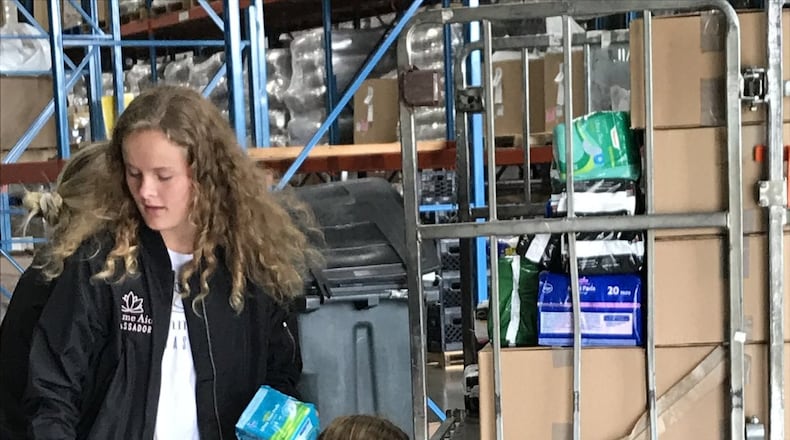 Dana Clark, co-founder of FemmeAid, and her friend Claire Parker deliver menstrual products to the Food Bank. CONTRIBUTED