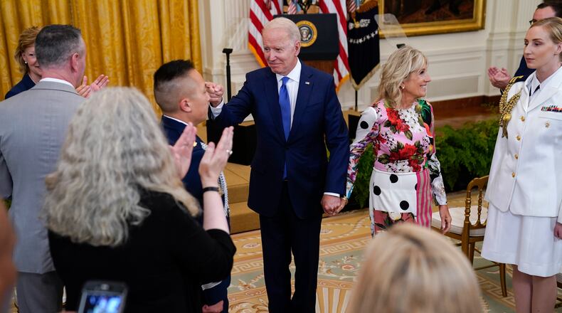 President Joe Biden points to Air Force Lt. Col. Bree Fram after speaking during an event to commemorate Pride Month, in the East Room of the White House, Friday, June 25, 2021, in Washington. (AP Photo/Evan Vucci)