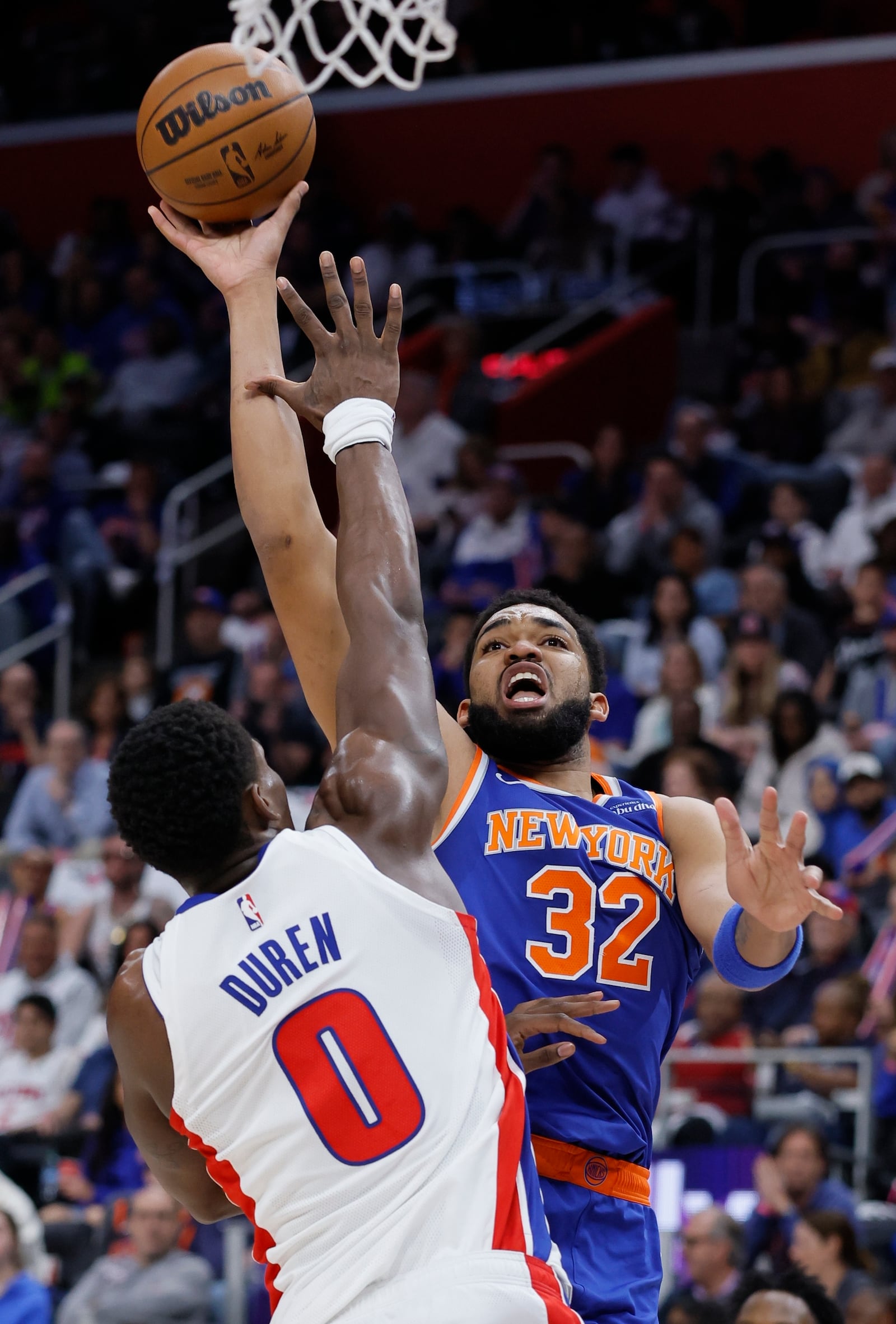 New York Knicks center Karl-Anthony Towns (32) gets a shot off against Detroit Pistons center Jalen Duren (0) during the first half of Game 4 of an NBA basketball first-round playoff series Sunday, April 27, 2025, in Detroit. (AP Photo/Duane Burleson)