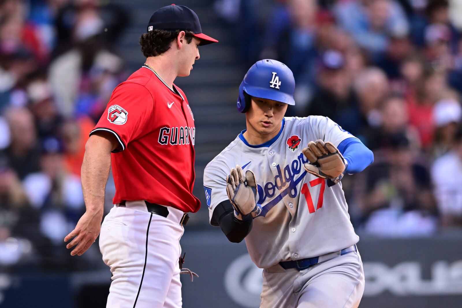 Los Angeles Dodgers' Shohei Ohtani (17) reacts after scoring on an RBI single by Freddie Freeman during the sixth inning of a baseball game against the Cleveland Guardians, Monday, May 26, 2025, in Cleveland. (AP Photo/David Dermer)