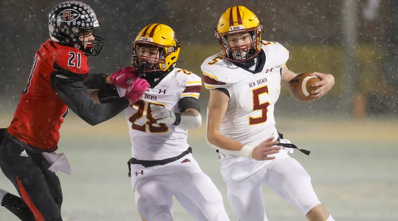New Bremen quarterback David Homan (5) looks for room to run against Fort Loramie in the Division VII, Region 28 championship game at Sidney on Saturday, Nov. 19, 2022. Michael Cooper/CONTRIBUTED