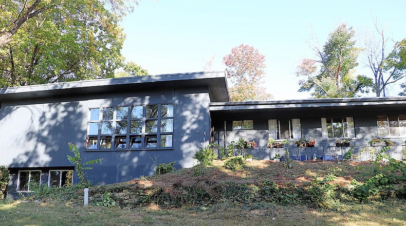 The brick-and-frame house has about 4,090 sq. ft. of living space, including the lower level. The terrace property has stone-edged gardens, a paved driveway to the 2-car garage. CONTRIBUTED PHOTO BY KATHY TYLER