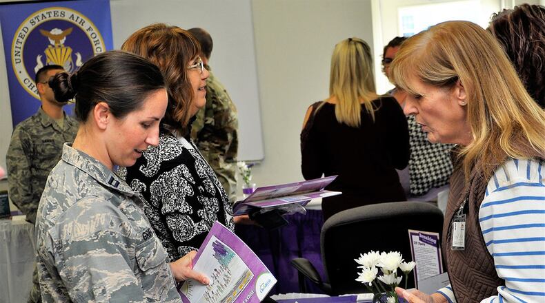 Capt. Morgan Griffo, deputy Sexual Assault and Response Coordinator officer, visits a community agency booth while attending the Wright-Patterson community partnership meeting Oct 12. (U.S. Air Force photo/Mark C. Lyle)