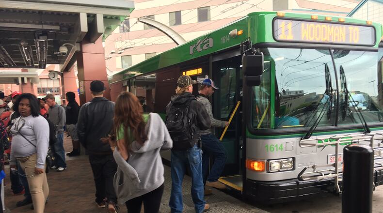 Riders gather to catch buses at the Greater Dayton Regional Transit Authority hub downtown on April 21. JOSH SWEIGART / STAFF