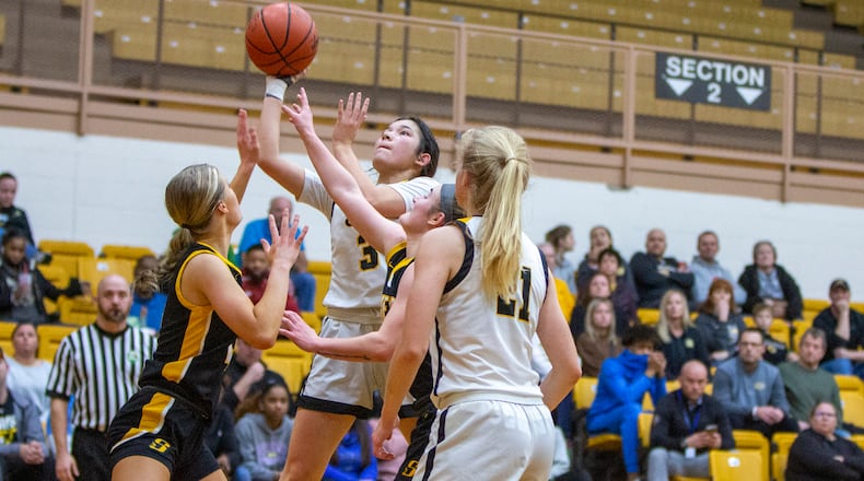Centerville's Kaitlyn Palomino shoots over the Sidney defense in the first half of Thursday night's tournament game at Vandalia Butler. Centerville won 51-49 in overtime. CONTRIBUTED/Jeff Gilbert