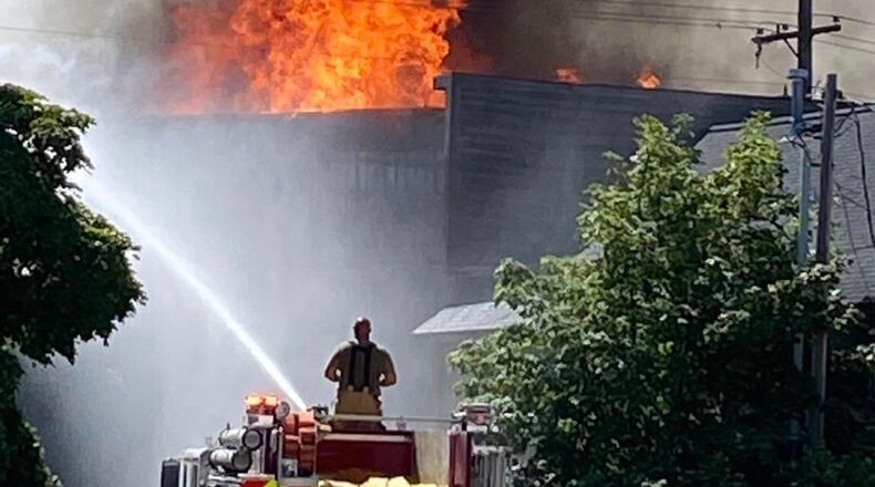 Firefighters from the Michigan Air National Guard’s Alpena Combat Readiness Training Center and the New York Air National Guard’s 106th Rescue Wing respond to a request for mutual-aid support at a large structure fire in downtown Alpena, Mich., July 21. The fire protection specialists had been supporting exercise Northern Strike 20, the National Guard’s annual joint fires readiness event, shifting quickly to assist the response when called upon by local authorities. (Michigan Air National Guard courtesy photo)