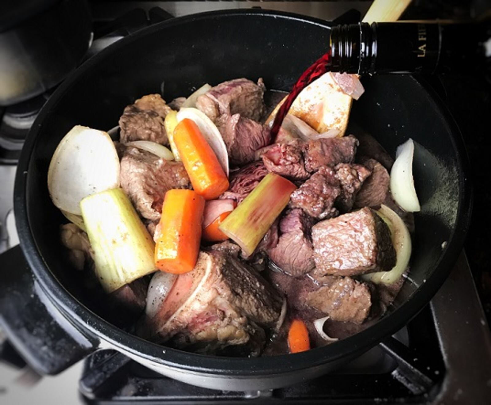 Adding wine to beef bourguignon.  (Leslie Brenner/Dallas Morning News/TNS) NO MAGAZINE SALES; MANDATORY CREDIT; NO SALES; INTERNET USE BY TNS CONTRIBUTORS ONLY