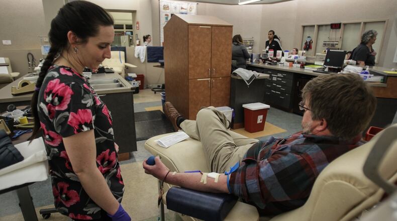 A man donates blood at the downtown Community Blood Center in Dayton on Thursday, March 19, 2020. JIM NOELKER/STAFF