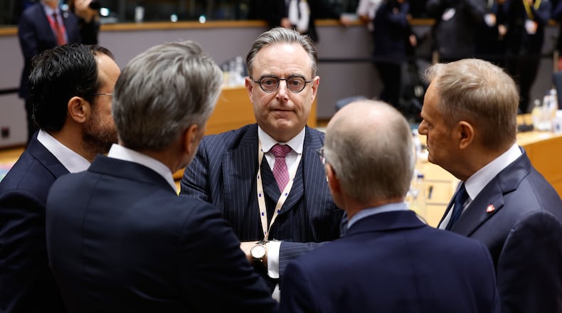 Belgium's Prime Minister Bart De Wever, center, speaks with from left, Cypriot President Nikos Christodoulides, Netherland's Prime Minister Dick Schoof, Luxembourg's Prime Minister Luc Frieden and Poland's Prime Minister Donald Tusk during a round table meeting at the EU Summit in Brussels, Thursday, Dec. 18, 2025. (AP Photo/Geert Vanden Wijngaert)