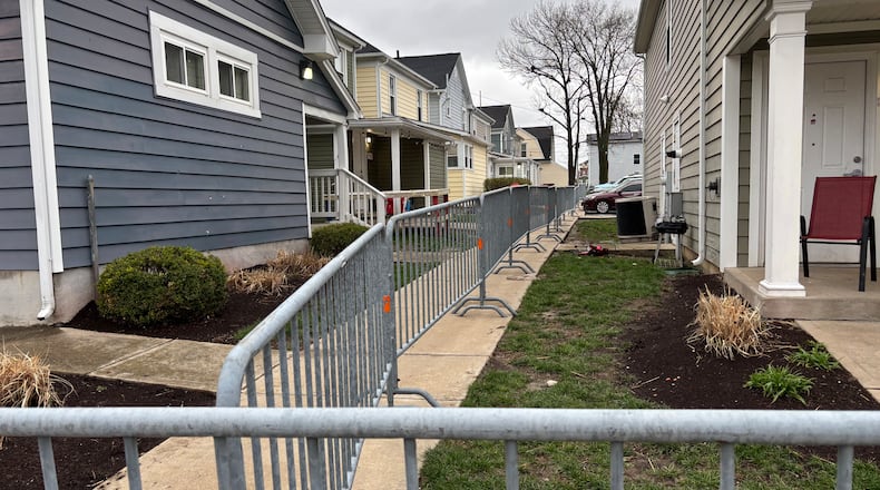 The city of Dayton has begun putting up fencing on Lowe Street Friday morning in anticipation of St. Patrick's Day festivities this weekend. Eileen McClory / staff