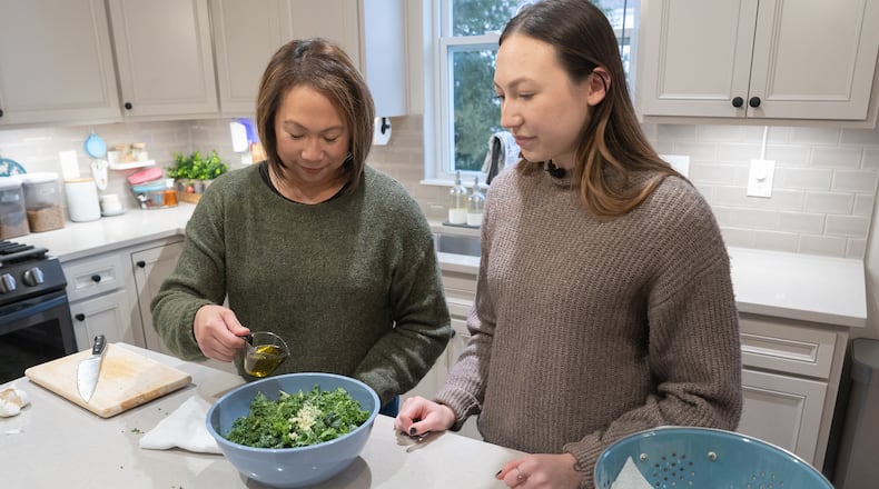 Alice and daughter Caitlin Henry prepare dinner. Alice’s gynecologist at the Ohio State University Wexner Medical Center is managing her menopause symptoms so Alice can get back to the things she loves. CONTRIBUTED
