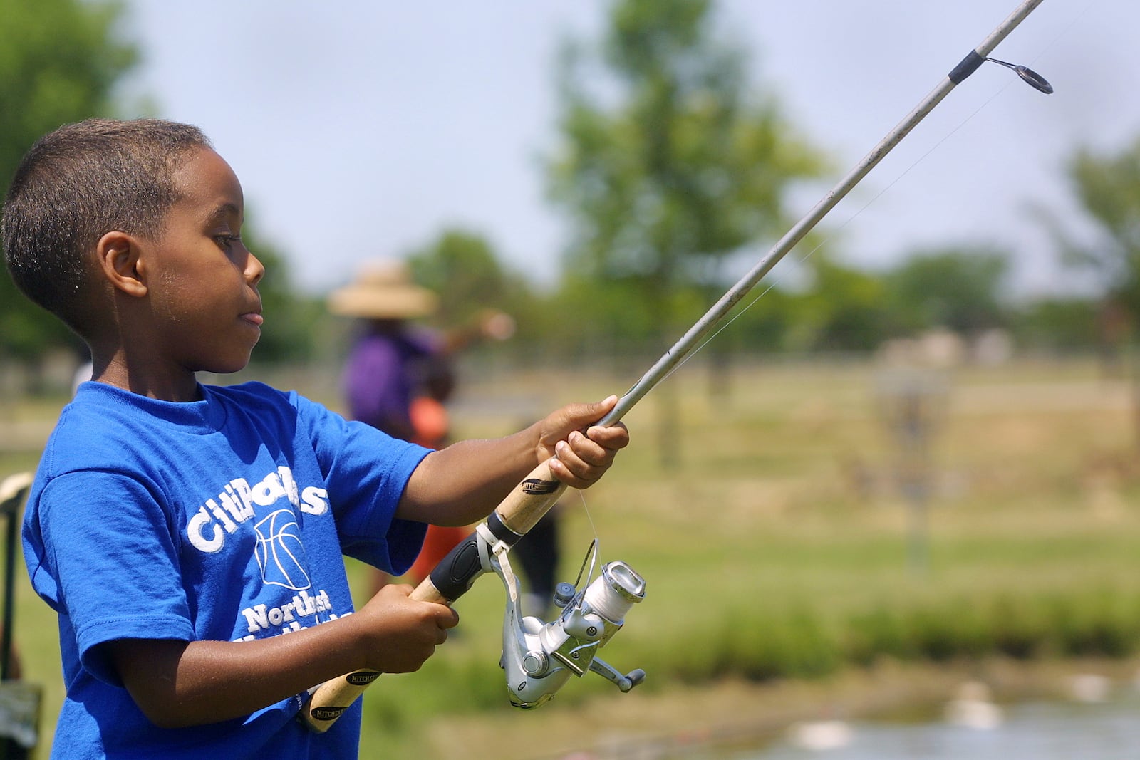 A 6-year-old enjoys a Saturday fishing with his father at Arthur O. Fisher Park’s Youth Fishing Derby in this 2005 file photo. STAFF