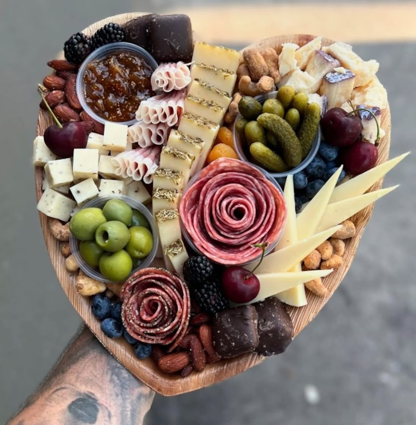 The heart-shaped charcuterie board by A Pretty Picnic have a variety of specialty meats, gourmet cheeses, fresh fruits, snack nuts, sweet treats and house-made jams. CONTRIBUTED
