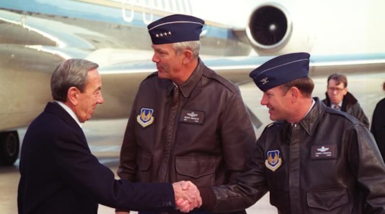 Col. Robbie Robinson, then-88th Air Base Wing commander, shakes then-Secretary of State Warren Christopher's hand as he and then-Air Force Materiel Command commander Gen. Henry Viccellio welcome members of the U.S. Department of State to Wright-Patterson Air Force Base for the Dayton Peace Accords. Air Force photo.