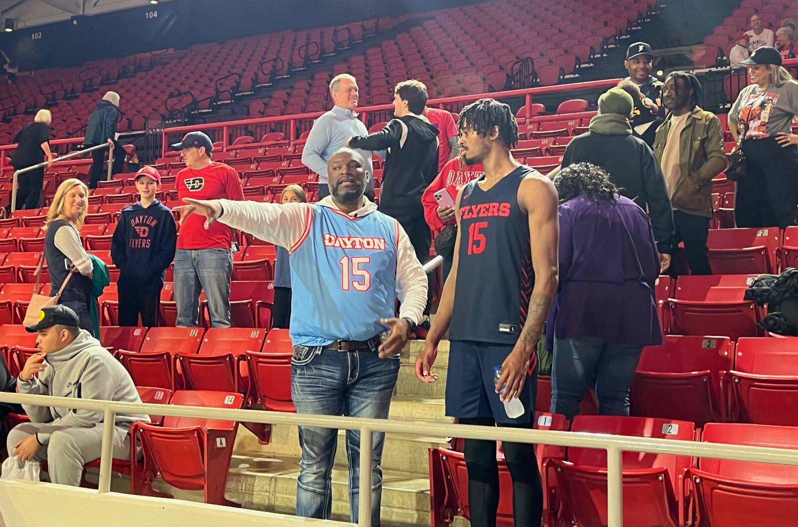 Dayton's DaRon Holmes talks to his dad DaRon Sr. after a victory against Davidson on Saturday, Dec. 31, 2022, at Belk Arena in Davidson, N.C. David Jablonski/Staff