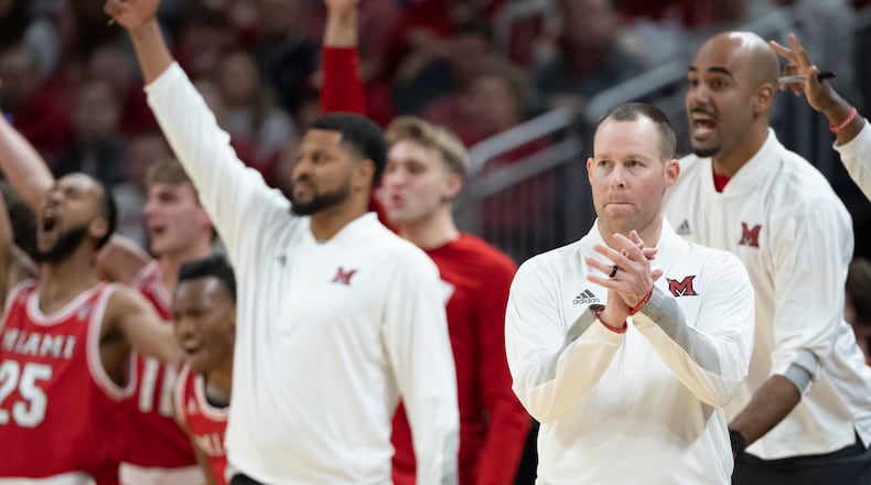 Miami head coach Travis Steele, front right, reacts during the first half of an NCAA college basketball game against Indiana, Sunday, Nov. 20, 2022. Miami defeated Eastern Illinois on Sunday. (AP Photo/Marc Lebryk)