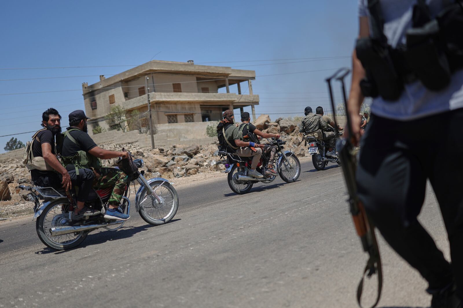 Bedouin fighters ride motorcycles as they deploy at Mazraa village on the outskirts of Sweida city, during clashes between the Bedouin clans and Druze militias, southern Syria, Friday, July 18, 2025. (AP Photo/Ghaith Alsayed)