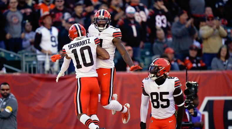 Cleveland Browns' Donovan Peoples-Jones (11) celebrates a touchdown reception with Anthony Schwartz (10) and David Njoku (85) during the first half of an NFL football game against the Cincinnati Bengals, Sunday, Nov. 7, 2021, in Cincinnati. (AP Photo/Bryan Woolston)
