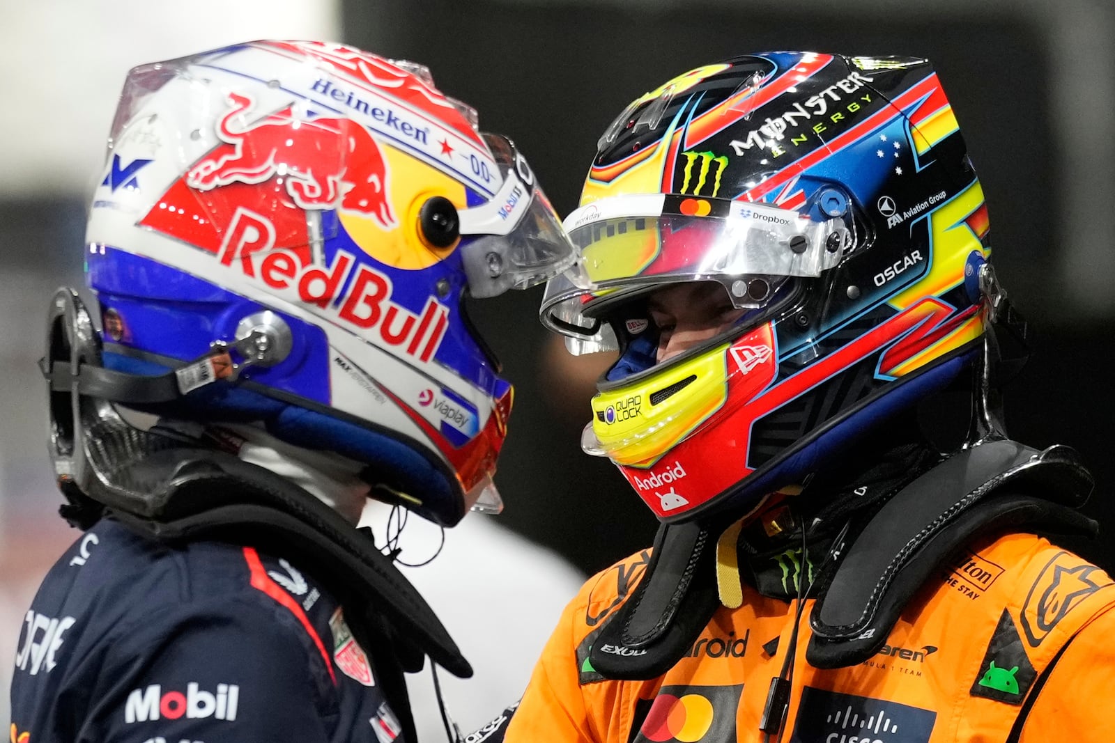 Red Bull driver Max Verstappen of the Netherlands, pole position, left, cheers with McLaren driver Oscar Piastri of Australia, second fastest time, after the qualifying session ahead of the Formula One Saudi Arabian Grand Prix at the Jeddah Corniche Circuit in Jeddah, Saudi Arabia, Saturday, April 19, 2025. (AP Photo/Darko Bandic)