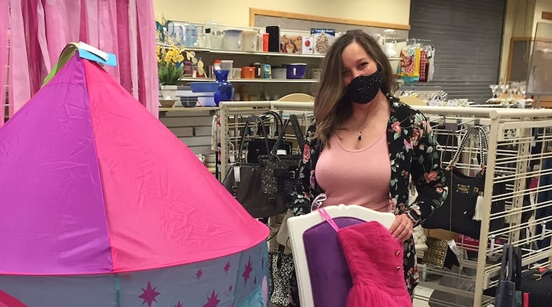 Thrift Shop manager Beth Newberry prepares a display of children’s items. The Wright-Patterson Officers’ Spouses’ Club consulted with the 88th Medical Group’s Public Health Flight and instituted a number of COVID-19 measures before reopening the shop. SKYWRIGHTER PHOTO/AMY ROLLINS