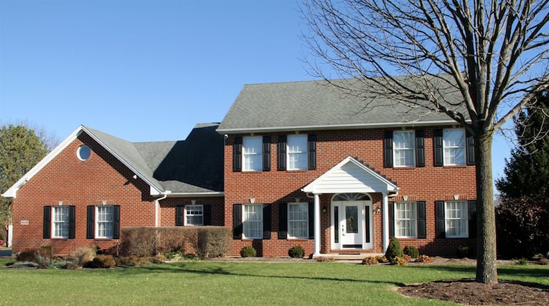 The Colonial-style 2-story has 4 bedrooms, updated formal areas, a finished basement with recreation room and bonus room, possible first-floor bedroom, a covered rear porch and a 3-car garage. CONTRIBUTED PHOTOS BY KATHY TYLER