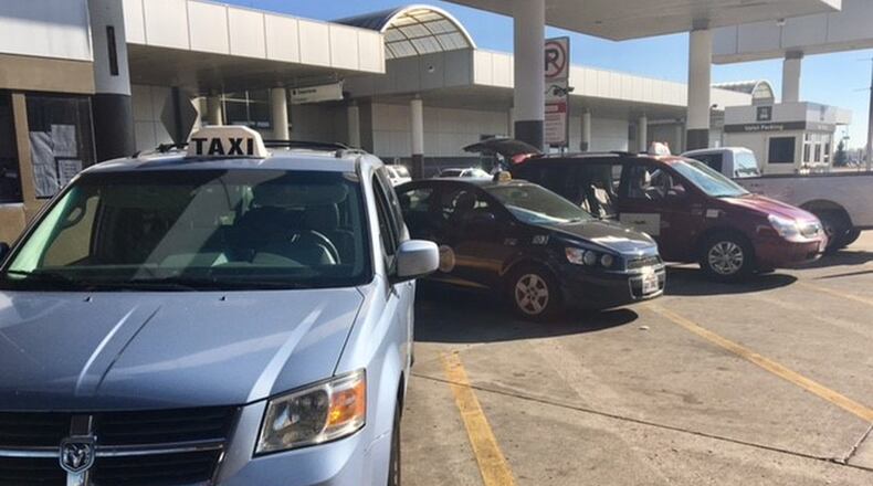 Taxis park in the queuing area of the Dayton International Airport. CAROLINE REINWALD / STAFF
