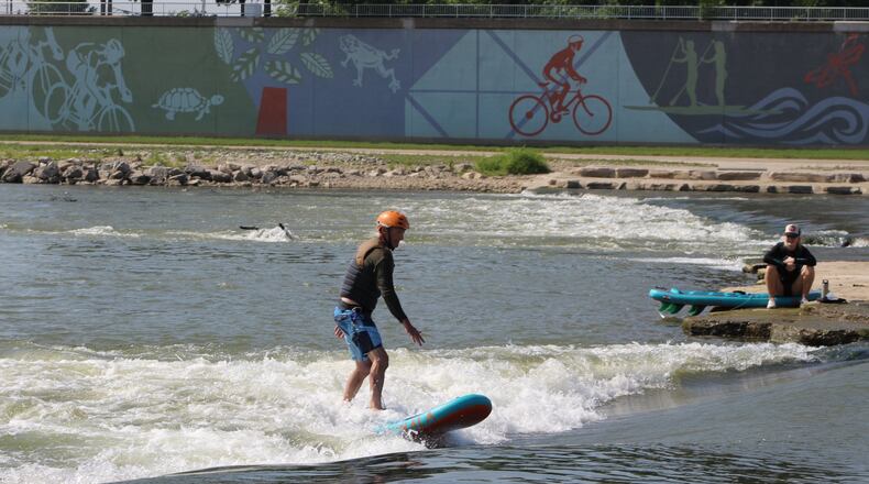 People surf the River Run at RiverScape MetroPark earlier this year. CORNELIUS FROLIK / STAFF