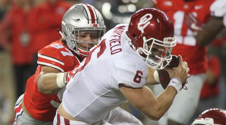 Ohio State's Nick Bosa tackles Oklahoma's Baker Mayfield on Saturday, Sept. 9, 2017, at Ohio Stadium in Columbus. David Jablonski/Staff
