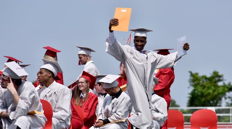Northridge High School graduate Michael Edward Spears celebrates Saturday. after receiving his diploma. The Northridge and Harrison Twp. areas were hit hard by a tornado on Memorial Day, just days before the graduation. NICK GRAHAH/STAFF PHOTO