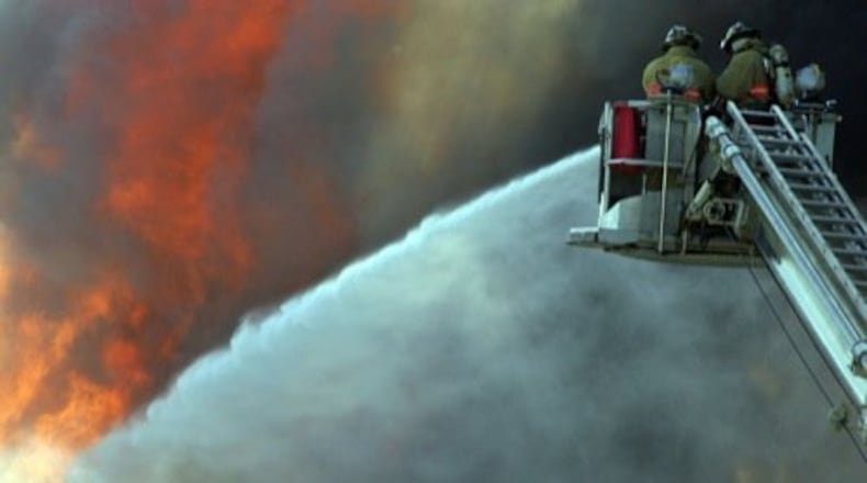 In this Oct. 2008 file photo, Troy firefighters battle a fully engulfed structure fire at Ohio Valley Wood Recycling Company on 1375 S. Union Street. STAFF PHOTO