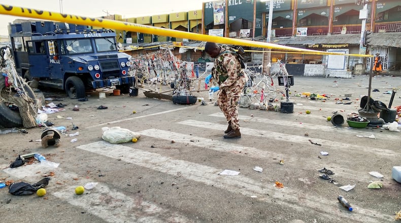 A soldier inspects the aftermath of Monday's bomb blast at a market in Maiduguri, Nigeria, Tuesday, March 17, 2026. (AP Photo/Jossy Ola )