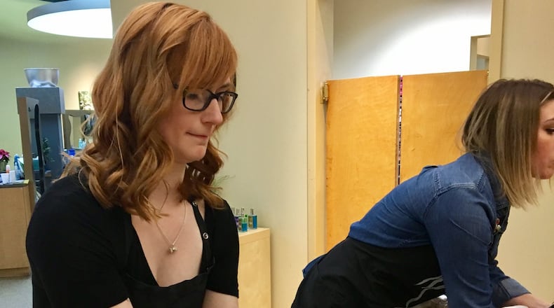 Morgan Mach shampoos a customer’s hair at Michael’s Salon and Spa in Centerville, Dec. 22, 2017. Lawmakers are considering whether to lower the number of training hours needed to get a cosmetology license in Ohio. KATIE WEDELL/STAFF