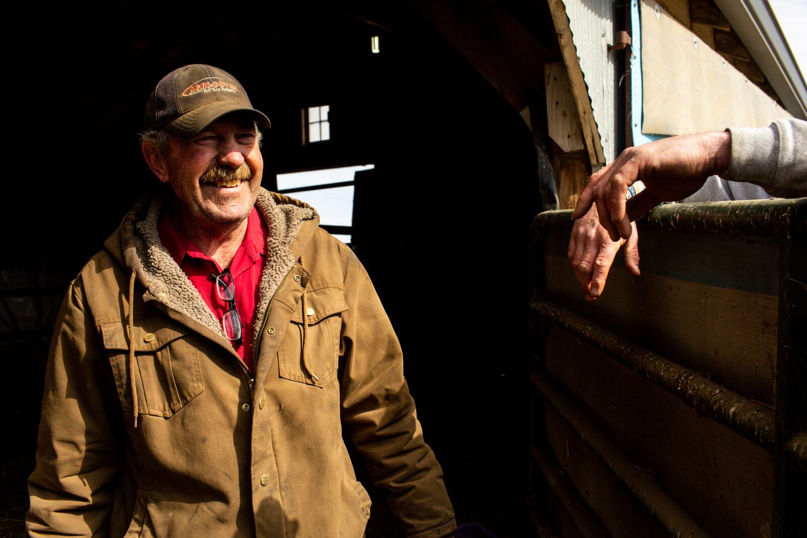 Mike Klipfel, a neighbor of Jared Bossly, talks to Bossly on his ranch in Mansfield, S.D., on Tuesday, March 11, 2025. The two became friends during surveying efforts by Summit Carbon Solutions. (AP Photo/Nicole Neri)